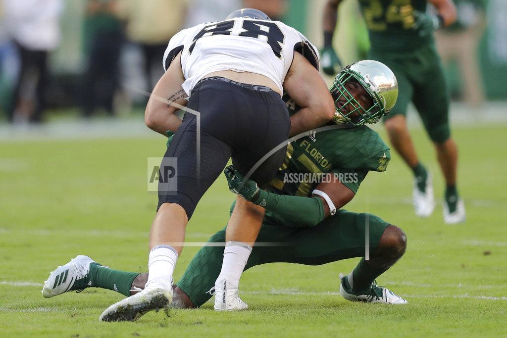 Mike Carlson Central Florida's Jake Hescock runs through the tackle of South Florida's Naytron Culpepper during the first half of an NCAA college football game Friday, Nov. 23, 2018, in Tampa, Fla. (AP Photo/Mike Carlson)