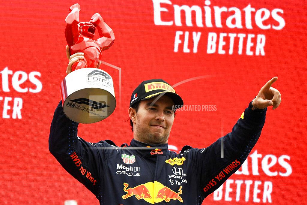 Nicolas Tucat Red Bull driver Sergio Perez of Mexico celebrates from the podium his third place after the French Formula One Grand Prix at the Paul Ricard racetrack in Le Castellet, southern France, Sunday, June 20, 2021. (Nicolas Tucat/Pool via AP)