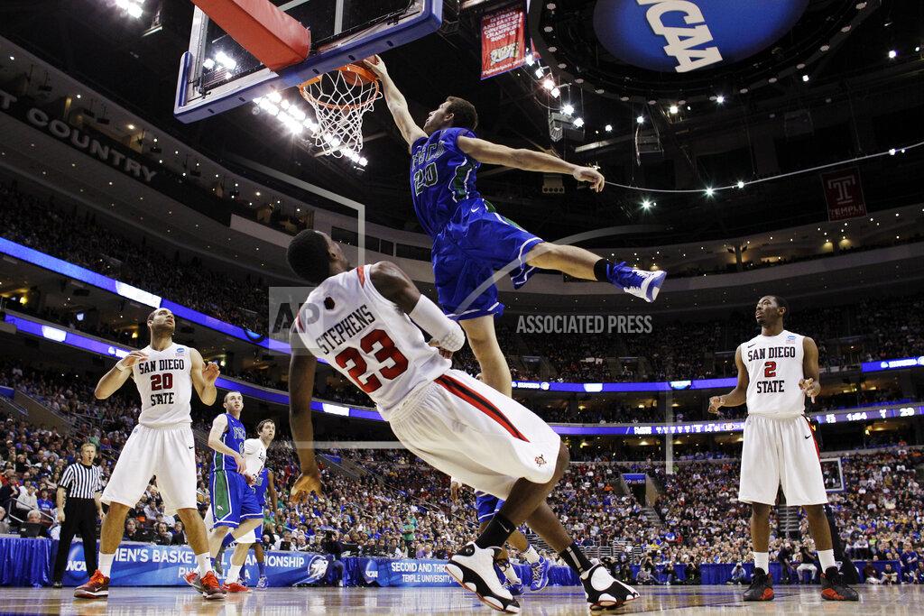 Matt Slocum FILE - In this March 24, 2013, file photo, Florida Gulf Coast's Chase Fieler, top, dunks over San Diego State's Deshawn Stephens during the first half of a third-round game of the NCAA college basketball tournament in Philadelphia. The Dunk City Effect, as it's called, accounted for a 35 percent increase in freshman applications following the NCAA run, boosted enrollment from about 13,000 to more than 15,000, and the academic reputation has been enhanced with higher caliber students being admitted. (AP Photo/Matt Slocum, File)