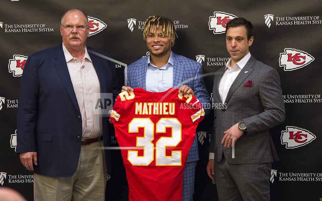 Tammy Ljungblad Kansas City Chiefs head coach Andy Reid, left, and general manager Brett Veach, right, introduce new safety Tyrann Mathieu during an NFL football news conference Thursday, March 14, 2019 at the team's practice facility in Kansas City, Mo. (Tammy Ljungblad/The Kansas City Star via AP)