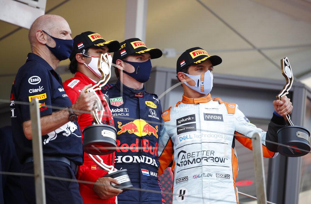 Sebastien Nogier First place Red Bull driver Max Verstappen of the Netherlands, center, second place Ferrari driver Carlos Sainz of Spain, second left, and third place Mclaren driver Lando Norris of Britain, right, celebrate with their trophies on the podium during the Monaco Grand Prix at the Monaco racetrack, in Monaco, Sunday, May 23, 2021. (Sebastien Nogier, Pool via AP)