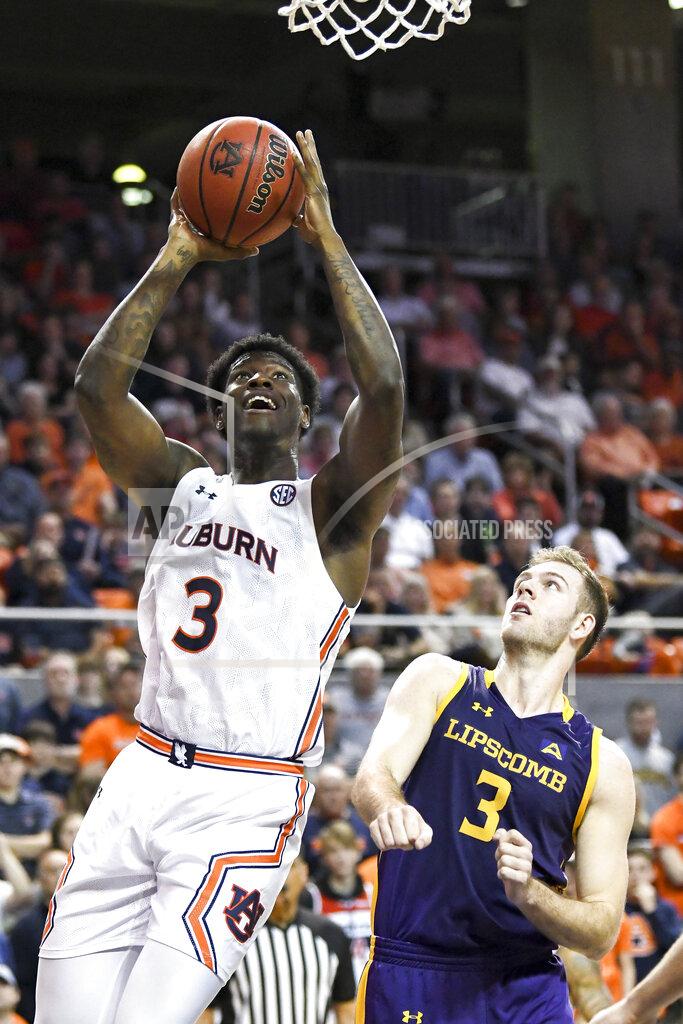 Julie Bennett Auburn forward Danjel Purifoy (3) scores two points while defended by Lipscomb guard Michael Buckland (3) during the second half of an NCAA college basketball game Sunday, Dec. 29, 2019, in Auburn, Ala. (AP Photo/Julie Bennett)