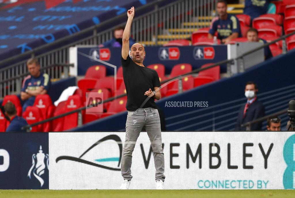 Matt Childs Manchester City's head coach Pep Guardiola gestures during the FA Cup semifinal soccer match between Arsenal and Manchester City at Wembley in London, England, Saturday, July 18, 2020. (AP Photo/Matt Childs,Pool)