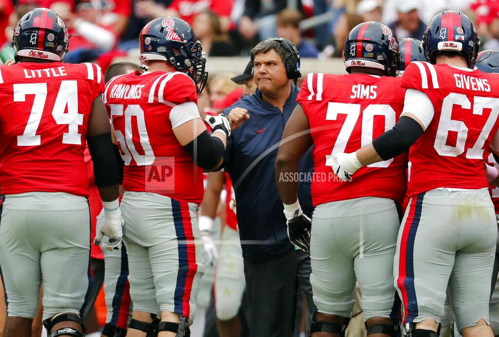 Rogelio V. Solis FILE - In this Oct. 20, 2018, file photo, Mississippi coach Matt Luke speaks with his players during an NCAA college football game against Auburn in Oxford, Miss. Luke guided Mississippi’s football program through the dark days of a two-year NCAA postseason ban. Now the Rebels believe the young coach--along with a few veteran coordinators--can push the program back in the Southeastern Conference’s elite. The Rebels have remade their coaching staff over the winter, paying more than $7 million over the next three years to offensive coordinator Rich Rodriguez and defensive coordinator Mike MacIntyre. The well-respected duo has more than two decades of Division I head coaching experience between them. (AP Photo/Rogelio V. Solis, File)