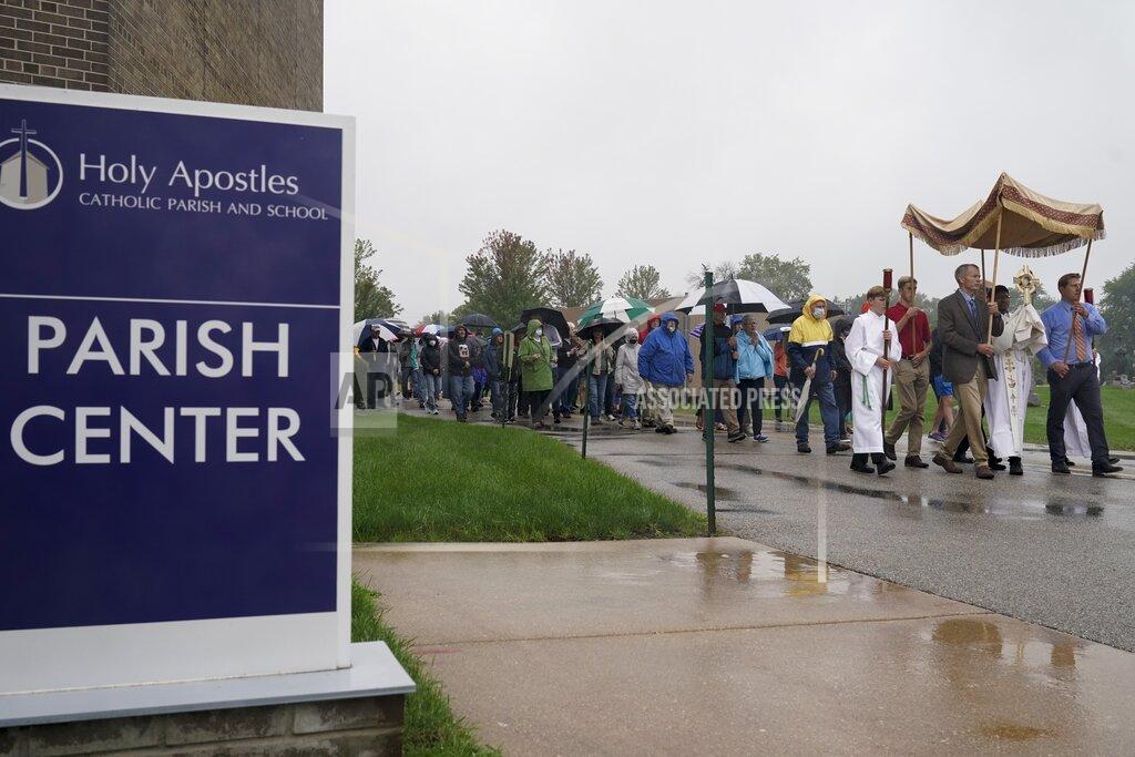 Churchgoers participate in a procession at the Holy Apostles Church in Milwaukee, Saturday, Sept. 12, 2020. For decades, Roman Catholic voters have been a pivotal swing vote in U.S. presidential elections, with a majority backing the winner — whether Republican or Democrat — nearly every time. (AP Photo/Morry Gash)