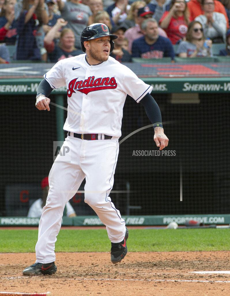 Phil Long Cleveland Indians' Roberto Perez scores on an RBI-single by Myles Straw during the seventh inning of a baseball game in Cleveland, Sunday, Sept. 26, 2021. (AP Photo/Phil Long)