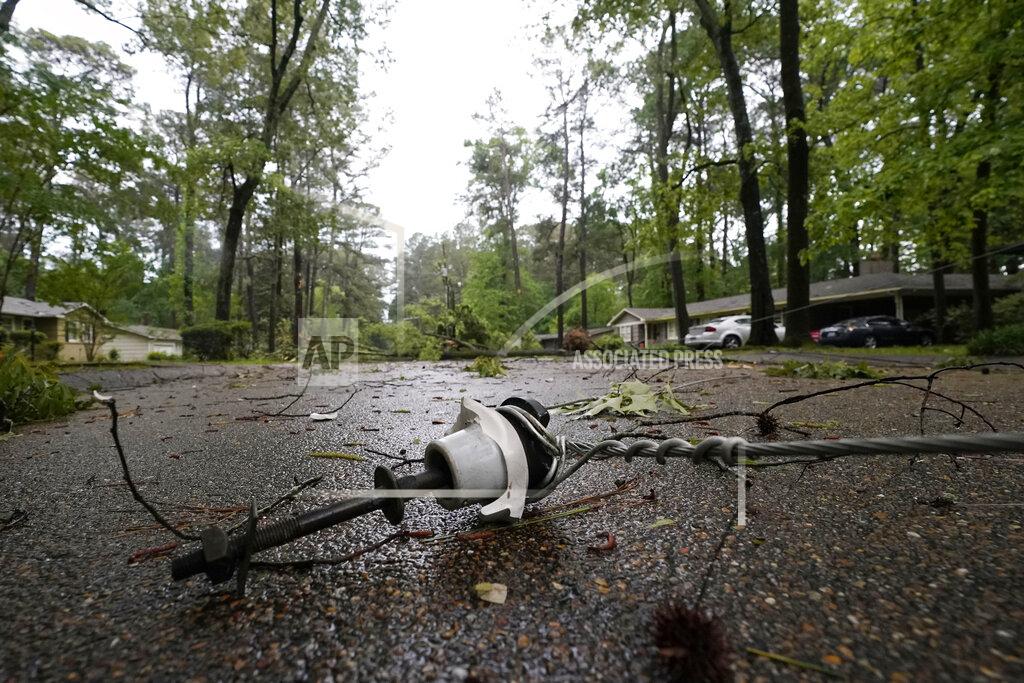 Rogelio V. Solis This downed utility line from a fallen tree in a northeast Jackson, Miss., neighborhood, was not an unfamiliar sight following a bout of high winds and severe weather, Tuesday afternoon, May 4, 2021. The severe weather was not unexpected, since the state was hit with a number of tornadoes on Sunday. (AP Photo/Rogelio V. Solis)