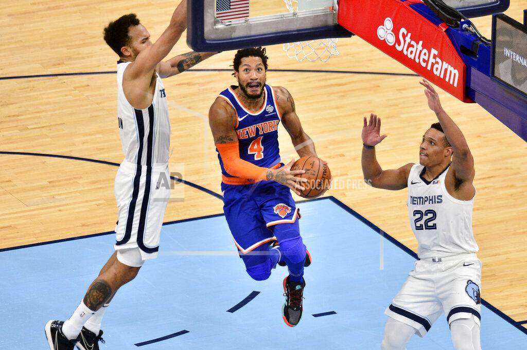 Brandon Dill New York Knicks guard Derrick Rose (4) jumps to shoot between Memphis Grizzlies guard Desmond Bane (22) and forward Kyle Anderson in the second half of an NBA basketball game Monday, May 3, 2021, in Memphis, Tenn. (AP Photo/Brandon Dill)