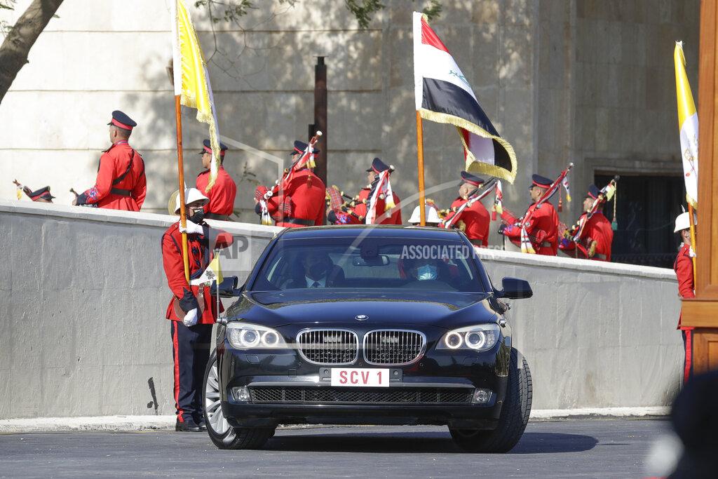 Andrew Medichini Pope Francis arrives at the Presidential Palace on an armored car, in Baghdad, Iraq, Friday, March 5, 2021. Pope Francis has arrived in Iraq to urge the country's dwindling number of Christians to stay put and help rebuild the country after years of war and persecution, brushing aside the coronavirus pandemic and security concerns. (AP Photo/Andrew Medichini)