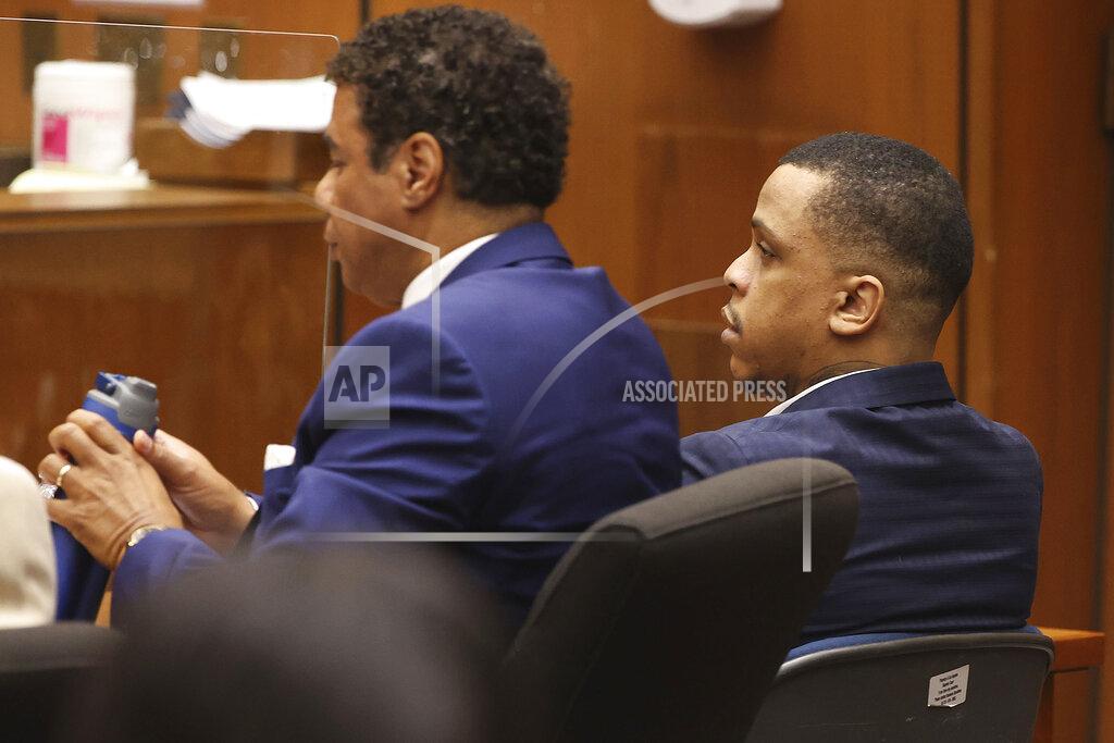 Frederick M. Brown Defendant Eric Holder, right, and his attorney Aaron Jansen listen during opening statements in Holder's murder trial, Wednesday, June 15, 2022, at Los Angeles Superior Court in Los Angeles. Holder, 32, faces one count of first degree-murder and two counts of attempted first-degree murder for the killing the Grammy Award-winning rapper Nipsey Hussle outside his clothing store three years ago. (Frederick M. Brown/Daily Mail.com via AP, Pool)