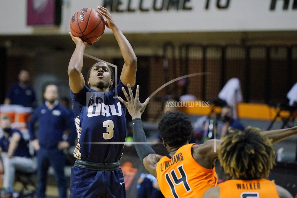 Sue Ogrocki Oral Roberts guard Max Abmas (3) shoots over Oklahoma State's Bryce Williams (14) during the first half of an NCAA college basketball game Tuesday, Dec. 8, 2020, in Stillwater, Okla. (AP Photo/Sue Ogrocki)