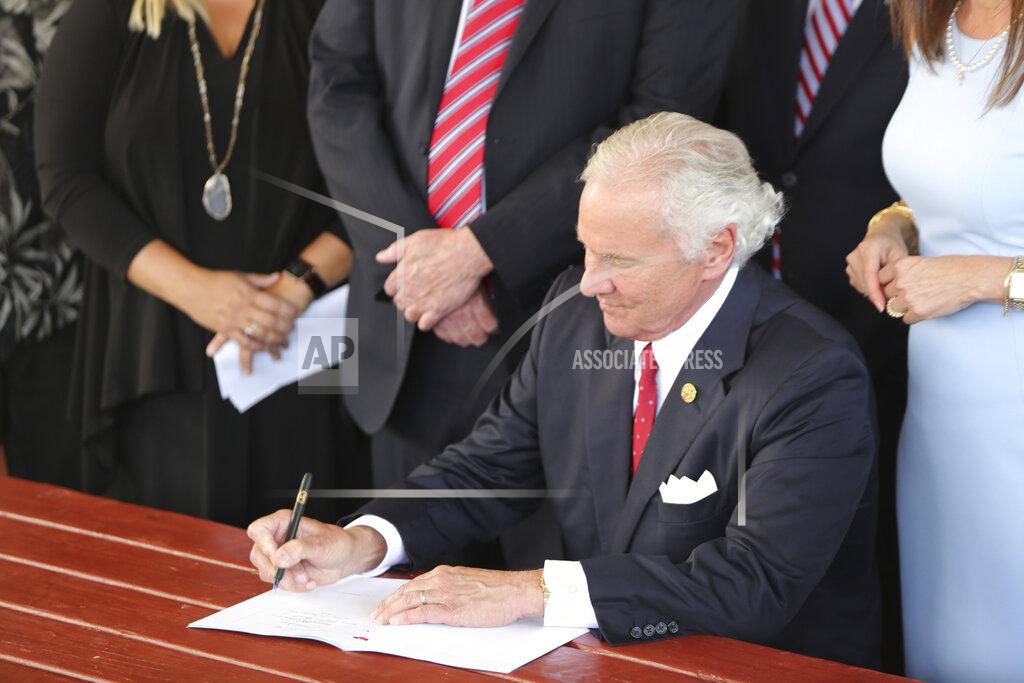 Jeffrey Collins South Carolina Gov. Henry McMaster signs a bill preventing people from suing businesses over COVID-19 on Thursday, June 24, 2021 at Cafe Strudel in West Columbia, South Carolina. The bill signing was ceremonial after the General Assembly passed the legislation in April. (AP Photo/Jeffrey Collins)