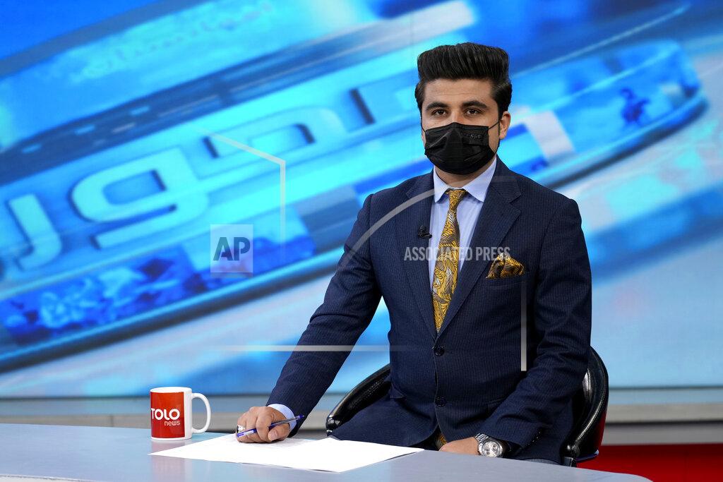 Ebrahim Noroozi TV anchor Nesar Nabil wears a face mask to protest the Taliban's new order that female presenters cover their faces, as he reads the news on TOLOnews, in Kabul, Afghanistan, Sunday, May 22, 2022. Afghanistan's Taliban rulers have begun enforcing an order requiring all female TV news anchors in the country to cover their faces while on-air. The move Sunday is part of a hard-line shift drawing condemnation from rights activists. (AP Photo/Ebrahim Noroozi)