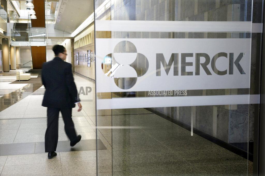 Mel Evans FILE - In this Dec. 18, 2014, file photo, a person walks through a Merck company building in Kenilworth, N.J. COVID-19 infections weighed Merck with so many people avoiding visits to hospitals or even the doctor early in the first quarter. The pharmaceutical company on Thursday, April 29, 2021, reported first-quarter earnings of $3.18 billion.(AP Photo/Mel Evans, File)