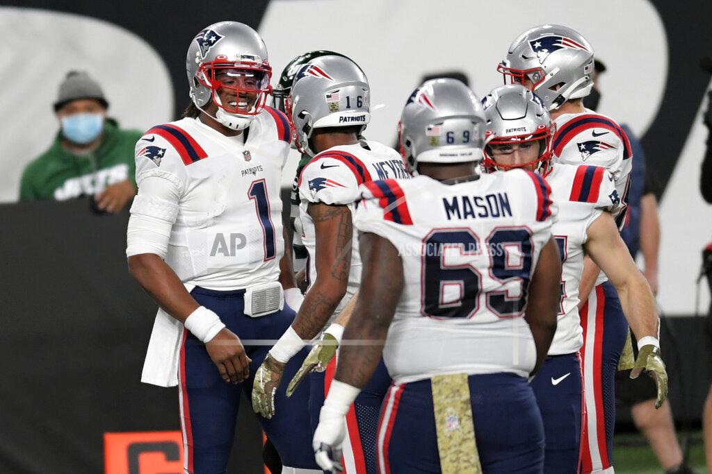 New England Patriots quarterback Cam Newton, left, celebrates his touchdown during the first half of an NFL football game against the New York Jets, Monday, Nov. 9, 2020, in East Rutherford, N.J. (AP Photo/Bill Kostroun)