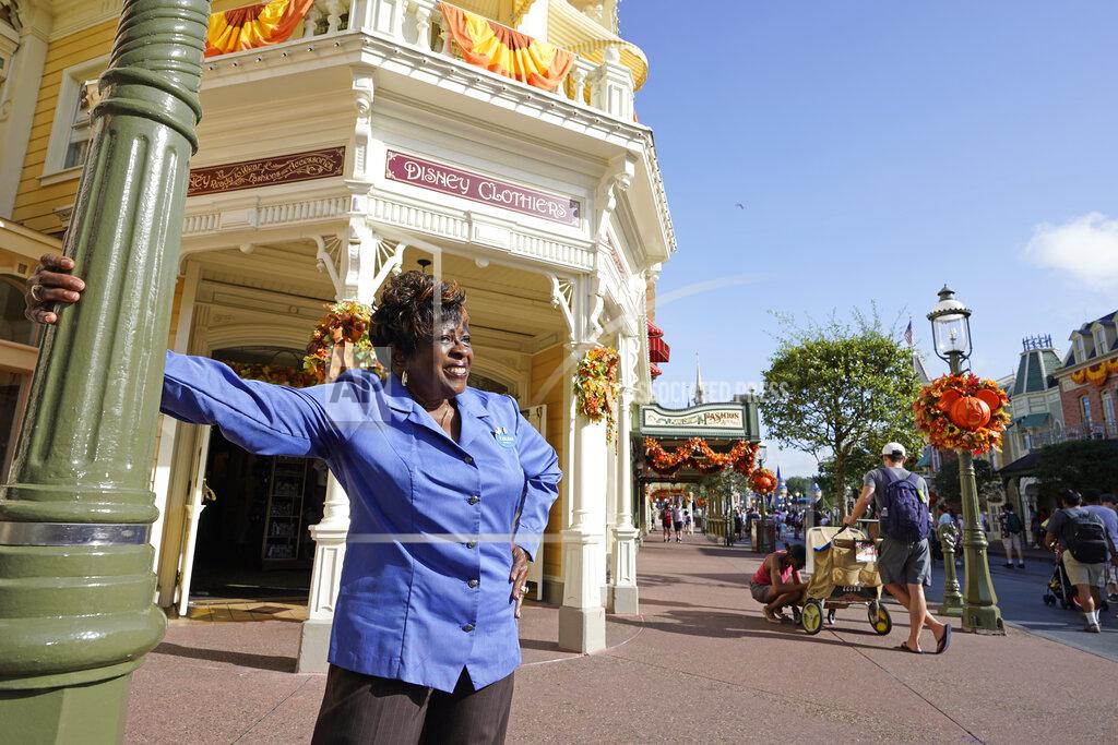 John Raoux Fifty-year employee Earliene Anderson stands on Main Street at the Magic Kingdom theme park at Walt Disney World Monday, Aug. 30, 2021, in Lake Buena Vista, Fla. "Disney has been my love, and it still is," Anderson said recently before starting her shift in merchandising. (AP Photo/John Raoux)