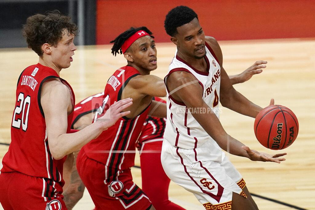 John Locher Southern California's Evan Mobley, right, passes around Utah's Mikael Jantunen, left, and Ian Martinez during the first overtime of an NCAA college basketball game in the quarterfinal round of the Pac-12 men's tournament Thursday, March 11, 2021, in Las Vegas. (AP Photo/John Locher)