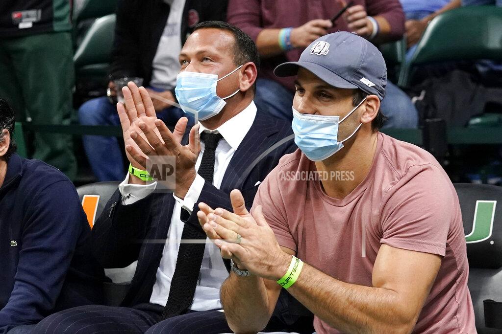 Lynne Sladky Former MLB player Alex Rodriguez, left, sits with former NFL wide receiver Eric Decker, right, during the first half of an NCAA college basketball game between Miami and North Carolina, Tuesday, Jan. 18, 2022, in Coral Gables, Fla. (AP Photo/Lynne Sladky)