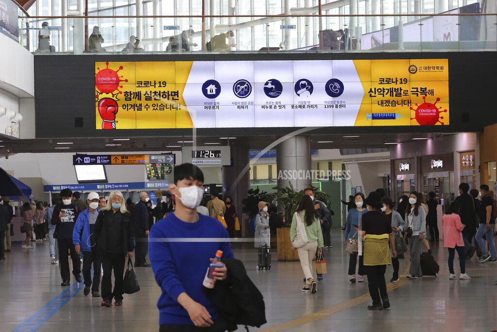 Ahn Young-Joon A screen shows about precautions against the new coronavirus at the Seoul Railway Station in Seoul, South Korea, Saturday, May 2, 2020. South Korea reported fresh cases of the new coronavirus are continuing a month-long downnturn. The sign reads: "Corona 19. If we practice together, we can overcome." (AP Photo/Ahn Young-joon)