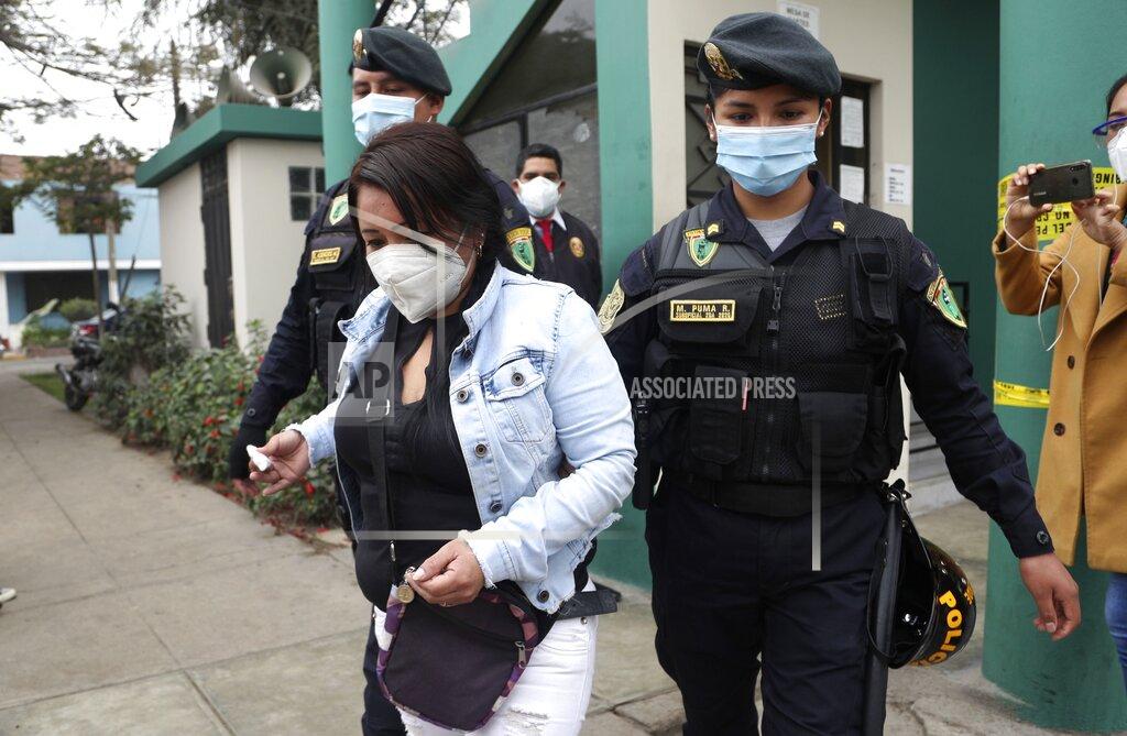 Martin Mejia Police officers escort a woman who was detained at a disco where thirteen people died during a stampede in Lima, Peru, Sunday, Aug. 23, 2020. Officials said the stampede happened at a disco in Peru after a police raid to enforce the country's lockdown during the coronavirus pandemic. (AP Photo/Martin Mejia)