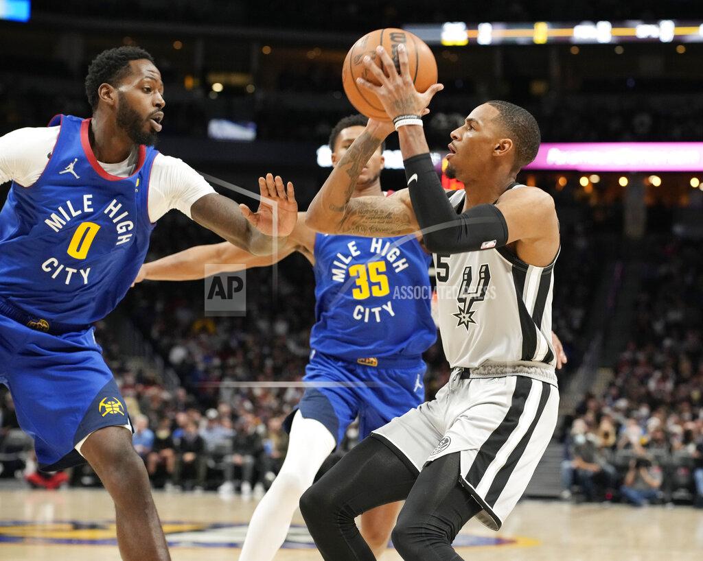 David Zalubowski San Antonio Spurs guard Dejounte Murray, right, prepares to shoot as Denver Nuggets forward JaMychal Green, left, and guard P.J. Dozier defend during the first half of an NBA basketball game Friday, Oct. 22, 2021, in Denver. (AP Photo/David Zalubowski)