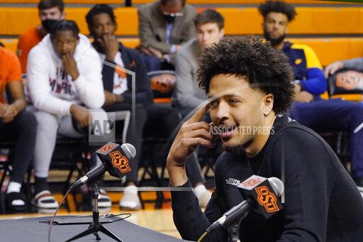 Sue Ogrocki With his teammates looking on at rear, Cade Cunningham announces that he will enter the NBA draft after a dynamic freshman season that saw him named a first-team AP All-American, Thursday, April 1, 2021, in Stillwater, Okla. (AP Photo/Sue Ogrocki)