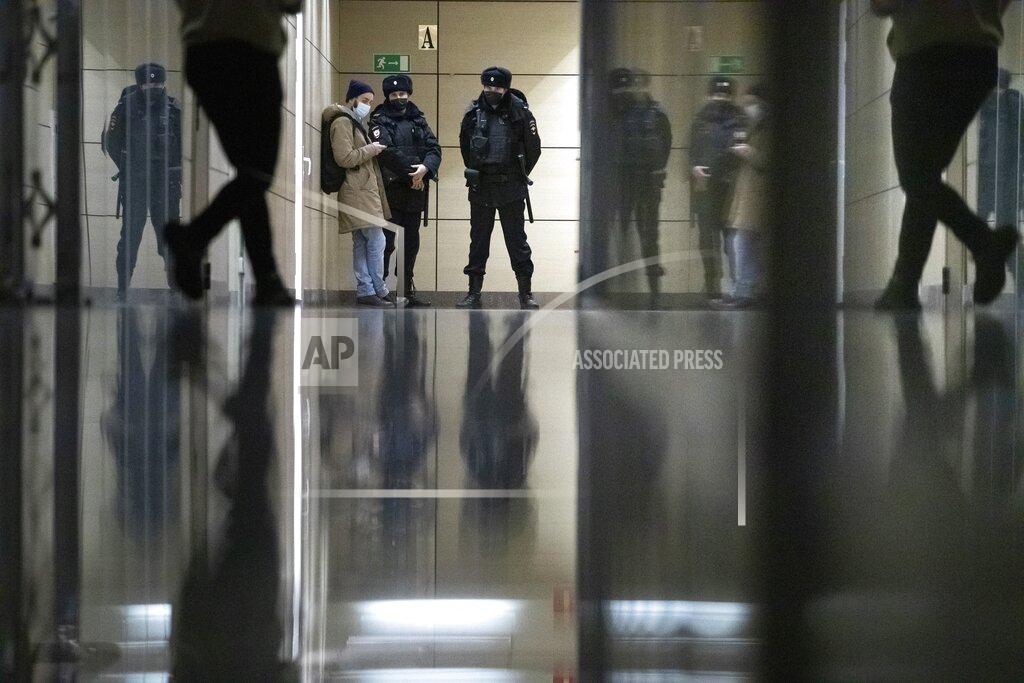 Pavel Golovkin Police stand guard at the Foundation for Fighting Corruption office in Moscow, Russia, Wednesday, Jan. 27, 2021. Police are searching the Moscow apartment of jailed Russian opposition leader Alexei Navalny, another apartment where his wife is living and two offices of his anti-corruption organization. Navalny's aides reported the Wednesday raids on social media. (AP Photo/Pavel Golovkin)