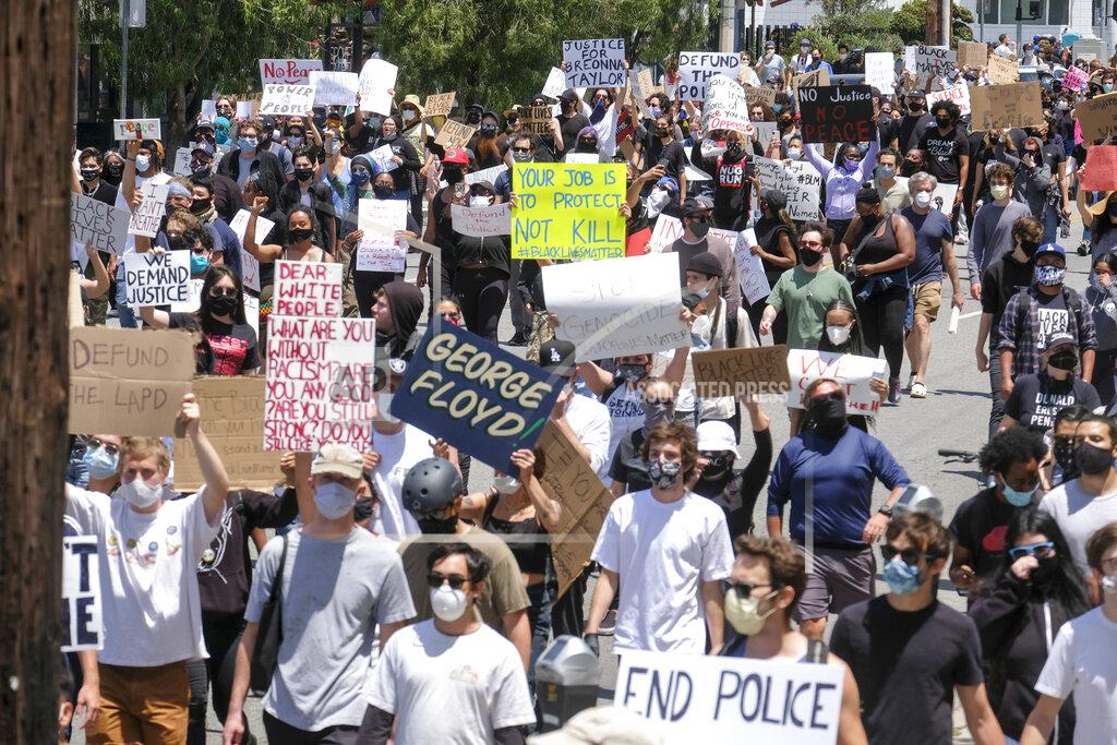 Ringo H.w. Chiu Protesters march on a street during a protest over the death of George Floyd, who died on Memorial Day after being taken into custody by Minneapolis police, in Los Angeles, Saturday, May 30, 2020. Floyd died after a police officer pressed his knee into his neck for several minutes even after he stopped moving and pleading for air. (AP Photo/Ringo H.W. Chiu)
