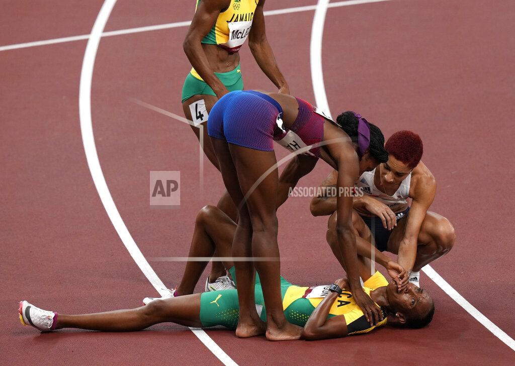 Francisco Seco Stephenie Mcpherson, of Jamaica reacts as she is helped from the track after the final of women's 400-meters at the 2020 Summer Olympics, Friday, Aug. 6, 2021, in Tokyo, Japan. (AP Photo/Francisco Seco)
