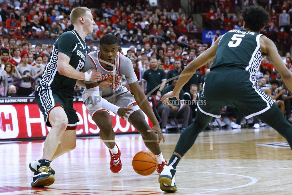 Jay Laprete Ohio State's E.J. Liddell, center, drives to the basket between Michigan State's Joey Hauser, left, and Max Christie during the second half of an NCAA college basketball game Thursday, March 3, 2022, in Columbus, Ohio. (AP Photo/Jay LaPrete)