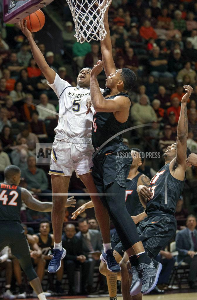 Don Petersen Notre Dame guard D.J. Harvey (5) shoots the ball against Virginia Tech forward Kerry Blackshear Jr. (24) during the first half of an NCAA college basketball game Tuesday, Jan. 1, 2019, in Blacksburg, Va. Va. Tech won 81-66. (AP Photo/Don Petersen)