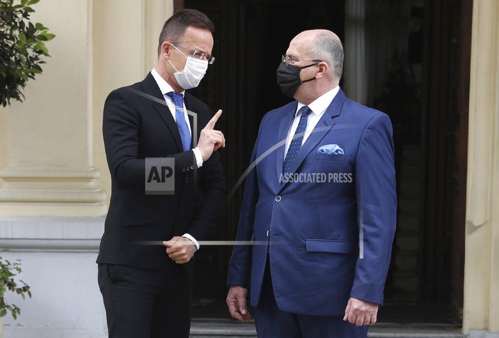 Czarek Sokolowski Poland's Foreign Minister Zbigniew Rau, right, walks with Hungarian Foreign Minister Peter Szijjarto during a meeting of foreign ministers from four central European countries known as the Visegrad Four in Lodz, Poland, Friday, May 14, 2021.(AP Photo/Czarek Sokolowski)