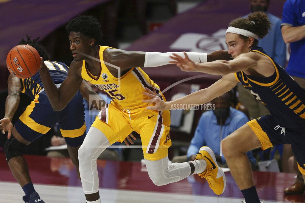 Stacy Bengs Minnesota forward Isaiah Ihnen (35) controls the ball next to UMKC forward Josiah Allick, right, during the first half of an NCAA college basketball game Thursday, Dec. 10, 2020, in Minneapolis. (AP Photo/Stacy Bengs)