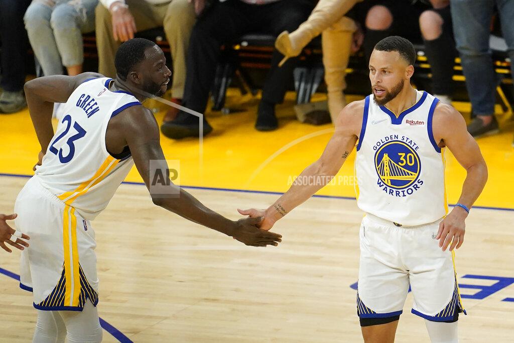 Jeff Chiu Golden State Warriors guard Stephen Curry (30) is congratulated by forward Draymond Green (23) after scoring against the Dallas Mavericks during the first half of Game 2 of the NBA basketball playoffs Western Conference finals in San Francisco, Friday, May 20, 2022. (AP Photo/Jeff Chiu)