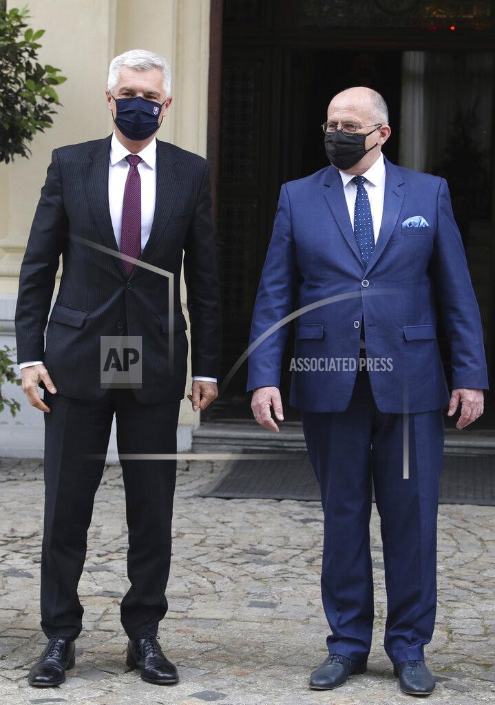 Czarek Sokolowski Poland's Foreign Minister Zbigniew Rau,right, gestures toward Slovak Foreign Minister Ivan Korcok, ahead of a meeting with regional counterparts in Lodz, Poland, Friday, May 14, 2021.(AP Photo/Czarek Sokolowski)