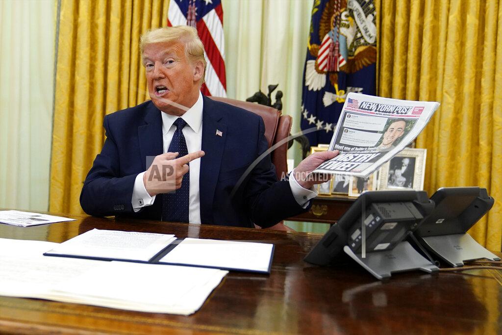 Evan Vucci President Donald Trump holds up a copy of the New York Post as he speaks before signing an executive order aimed at curbing protections for social media giants, in the Oval Office of the White House, Thursday, May 28, 2020, in Washington. (AP Photo/Evan Vucci)