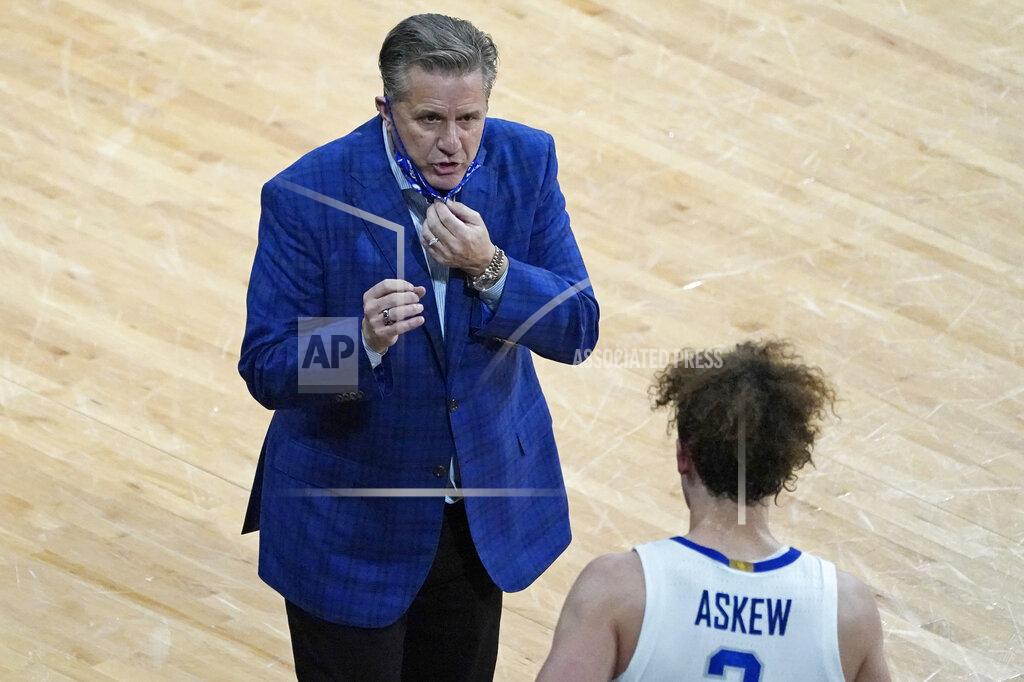 Rogelio V. Solis Kentucky head coach John Calipari, top, confers with guard Devin Askew (2) during the second half of an NCAA college basketball game against Mississippi State in Starkville, Miss., Saturday, Jan. 2, 2021. (AP Photo/Rogelio V. Solis)