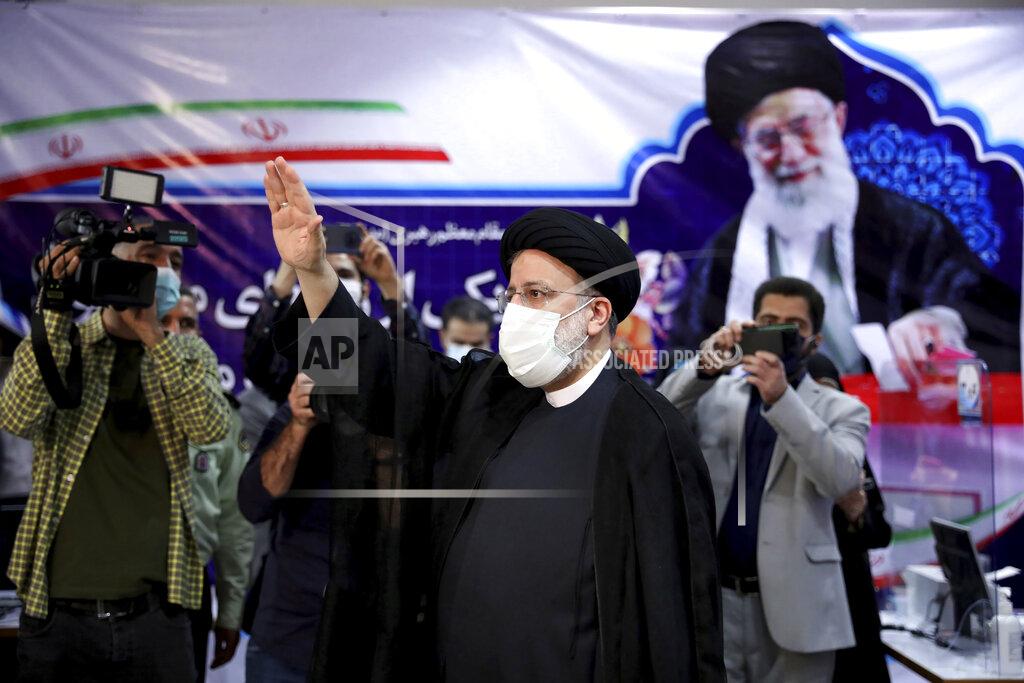 Ebrahim Noroozi Ebrahim Raisi, head of Iran's judiciary waves to media as he attends at the Interior Ministry to register his candidacy for the June 18 presidential elections at the elections headquarters of the Interior Ministry in Tehran, Iran, Saturday, May 15, 2021. (AP Photo/Ebrahim Noroozi)