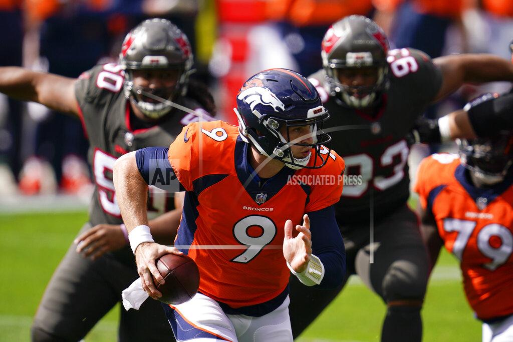 David Zalubowski Denver Broncos quarterback Jeff Driskel scrambles under pressure from Tampa Bay Buccaneers nose tackle Vita Vea, left, and defensive end Ndamukong Suh, right, during the first half of an NFL football game Sunday, Sept. 27, 2020, in Denver. (AP Photo/David Zalubowski)