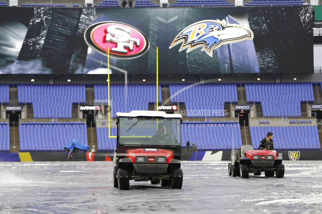 Julio Cortez Members of the ground crew use blowers to help dry off the tarp in preparation of an NFL football game between the Baltimore Ravens and the San Francisco 49ers, Sunday, Dec. 1, 2019, in Baltimore, Md. (AP Photo/Julio Cortez)