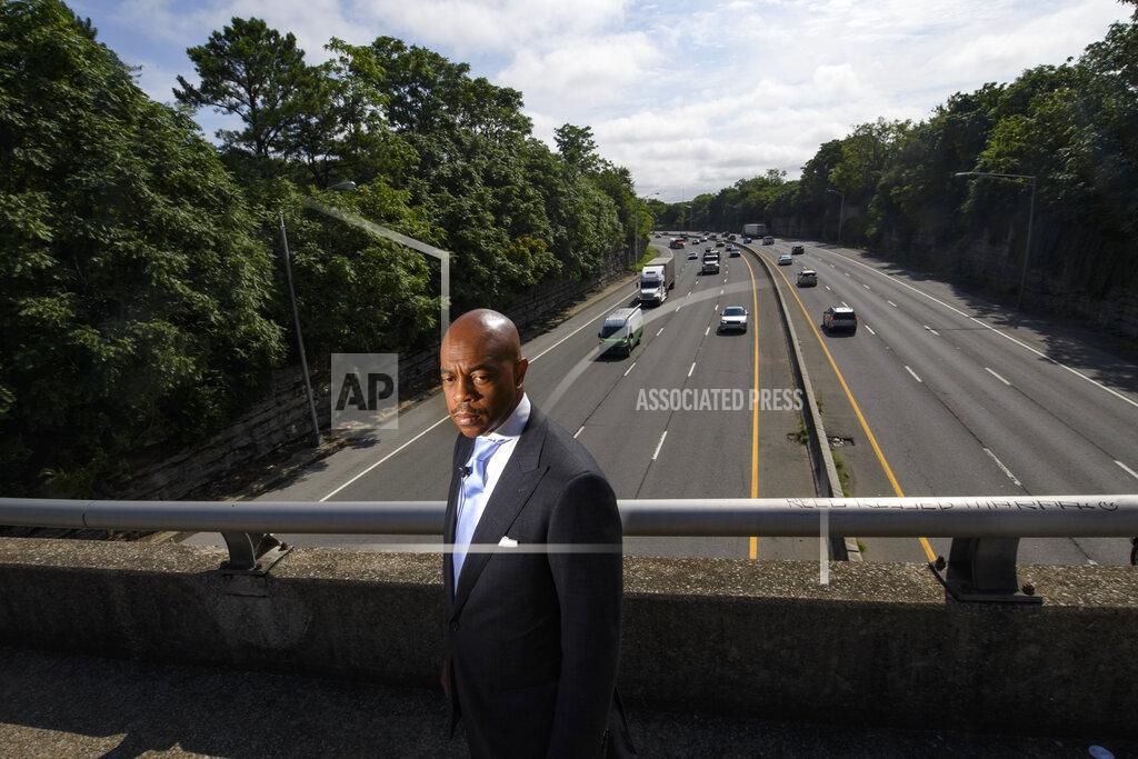 John Amis Tennessee State Rep. Harold Love, Jr. stands on an overpass over I-40, Monday, July, 19, 2021, near the site of his family's former home on the north side of Nashville, Tenn. Love Jr.'s father, a Nashville city councilman, was forced to sell his home near here to make way for the highway, but put up a fight in the 1960s against the rerouting of Interstate 40 because he believed it would stifle and isolate Nashville's Black community. Love Jr. is now part of a group pushing to build a cap across the highway, behind him, that creates a community space to help reunify the city. (AP Photo/John Amis)