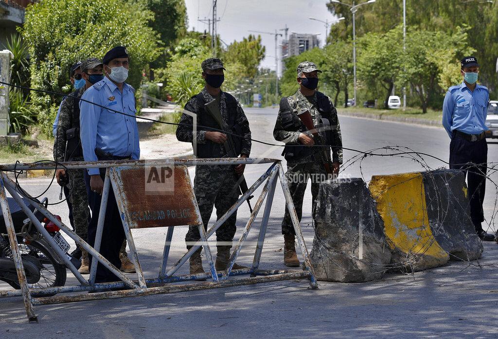 Anjum Naveed Pakistan paramilitary soldiers and a police officers stand guard at a checkpoint of a restricted area to help to contain the spread of new coronavirus, in Islamabad, Pakistan, Saturday, June 13, 2020. Capital administration sealed few areas of Islamabad following the decision taken on the advice of the Health Department and epidemiologists after hundreds of cases were reported from these areas. (AP Photo/Anjum Naveed)