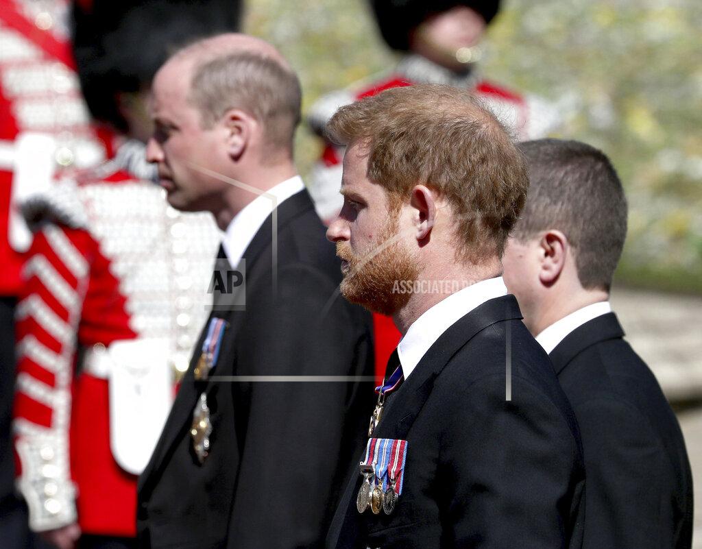 Gareth Fuller Britain's Prince William, left, and Prince Harry follow the coffin as it slowly makes its way in a ceremonial procession during the funeral of Britain's Prince Philip inside Windsor Castle in Windsor, England, Saturday, April 17, 2021. (Gareth Fuller/Pool via AP)