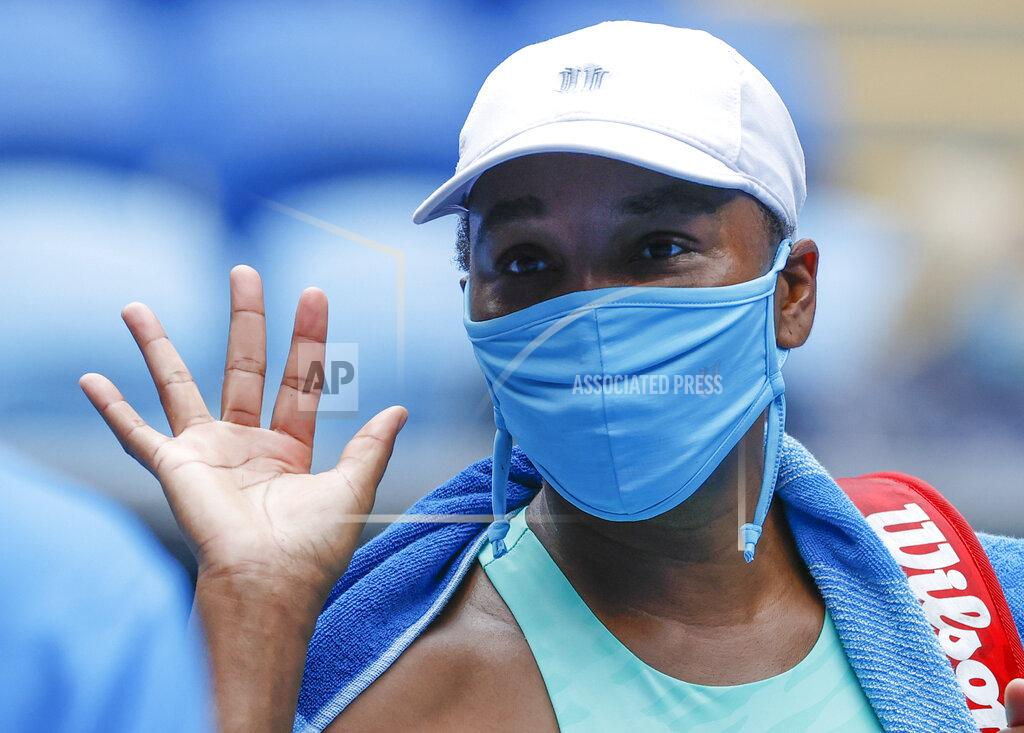 Rick Rycroft United States' Venus Williams waves after defeating Belgium's Kirsten Flipkens in their first round match at the Australian Open tennis championship in Melbourne, Australia, Monday, Feb. 8, 2021.(AP Photo/Rick Rycroft)