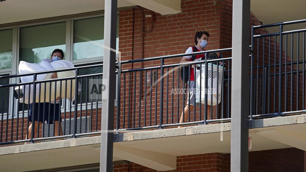 Gerry Broome Students begin to move their belongings out of Bragaw Hall at North Carolina State University in Raleigh, N.C., Thursday, Aug. 27, 2020. Thursday is the first day students will start moving out of campus housing due to continuing spread of COVID-19 clusters around campus. (AP Photo/Gerry Broome)