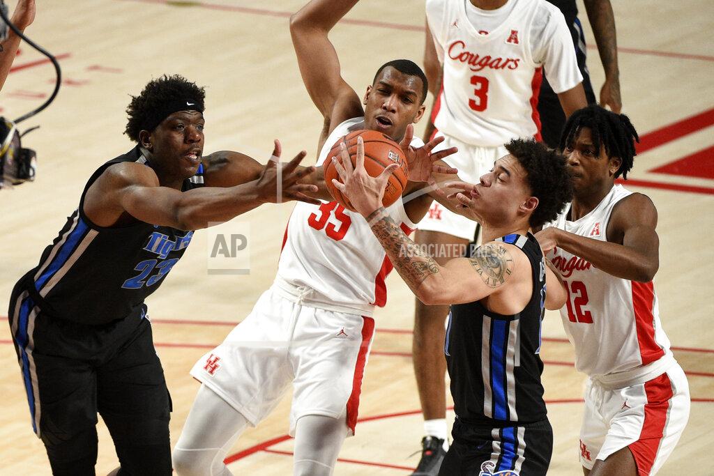 Eric Christian Smith Memphis center Malcolm Dandridge (23), Houston forward Fabian White Jr. (35), Memphis guard Lester Quinones, second from right, and Houston guard Tramon Mark (12) vie for a rebound during the first half of an NCAA college basketball game, Sunday, March 7, 2021, in Houston. (AP Photo/Eric Christian Smith)