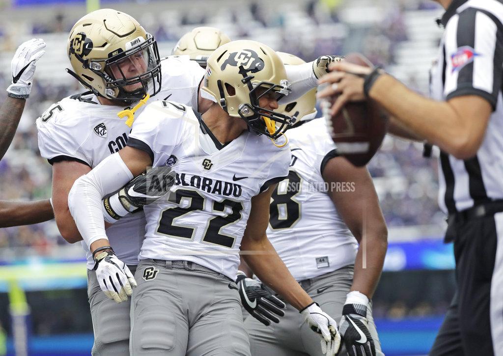 Ted S. Warren Colorado wide receiver Daniel Arias (22) celebrates with offensive lineman Brett Tonz, left, after Arias caught a pass for a touchdown against Washington during the first half of an NCAA college football game, Saturday, Oct. 20, 2018, in Seattle. (AP Photo/Ted S. Warren)