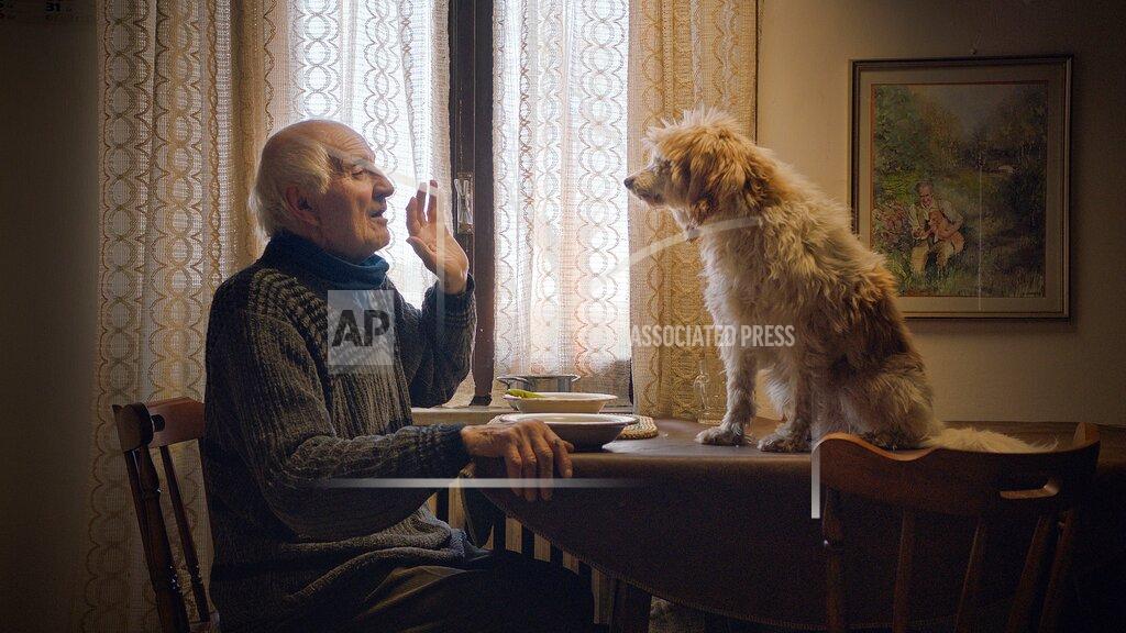 This image released by Sony Pictures Classics shows Aurelio Conterno and his dog Birba in a scene from