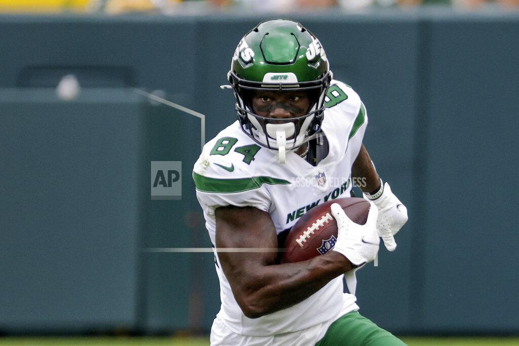 FILE- In this Saturday, Aug. 21, 2021, file photo, New York Jets' Corey Davis runs during the first half of a preseason NFL football game in Green Bay, Wis. Davis understands why he's with the New York Jets. And he's ready to show everyone the reason. The 26-year-old has 207 career catches for 2,851 yards and 11 touchdowns in 56 games. (AP Photo/Mike Roemer, File)