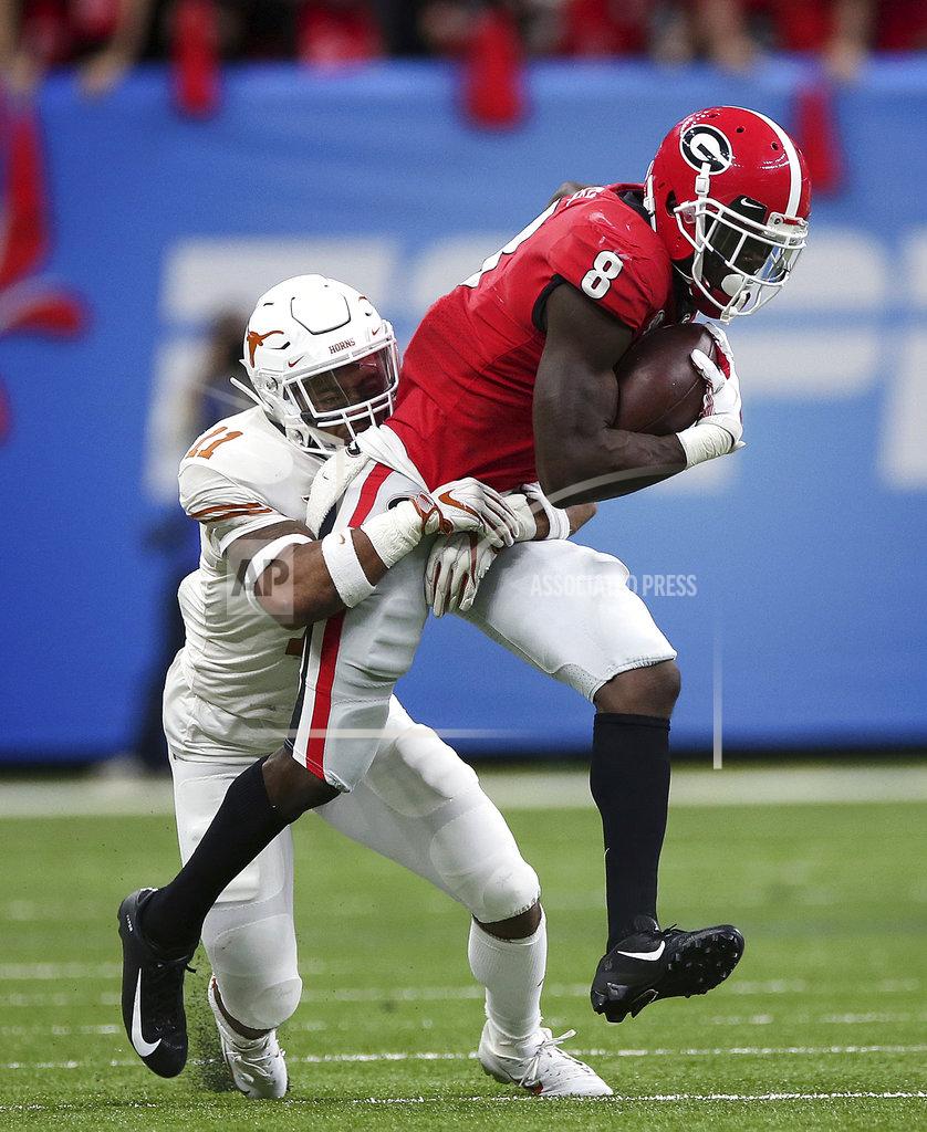 Rusty Costanza Georgia wide receiver Riley Ridley (8) carries against Texas defensive back P.J. Locke III (11) during the first half of the Sugar Bowl NCAA college football game in New Orleans, Tuesday, Jan. 1, 2019. (AP Photo/Rusty Costanza)